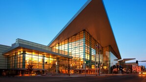 A modern building with a prominent triangular roof and extensive glass facade. - Aloft by Marriott Denver Downtown (Denver)
