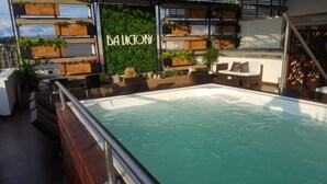 A rooftop pool area with a sign reading "LA UNCYONY" and multiple planters with greenery. - Isa Victory Hotel Boutique (Armenia)