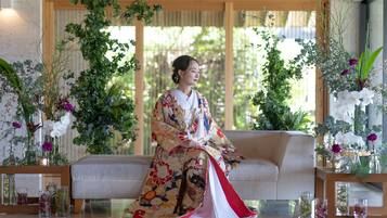 A traditional Japanese room with tatami flooring, a low wooden table, and a sofa.