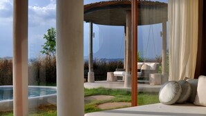 A modern outdoor living area with a pool, a wooden bench, and a view of the landscape. - Sala Khaoyai (Pak Chong)