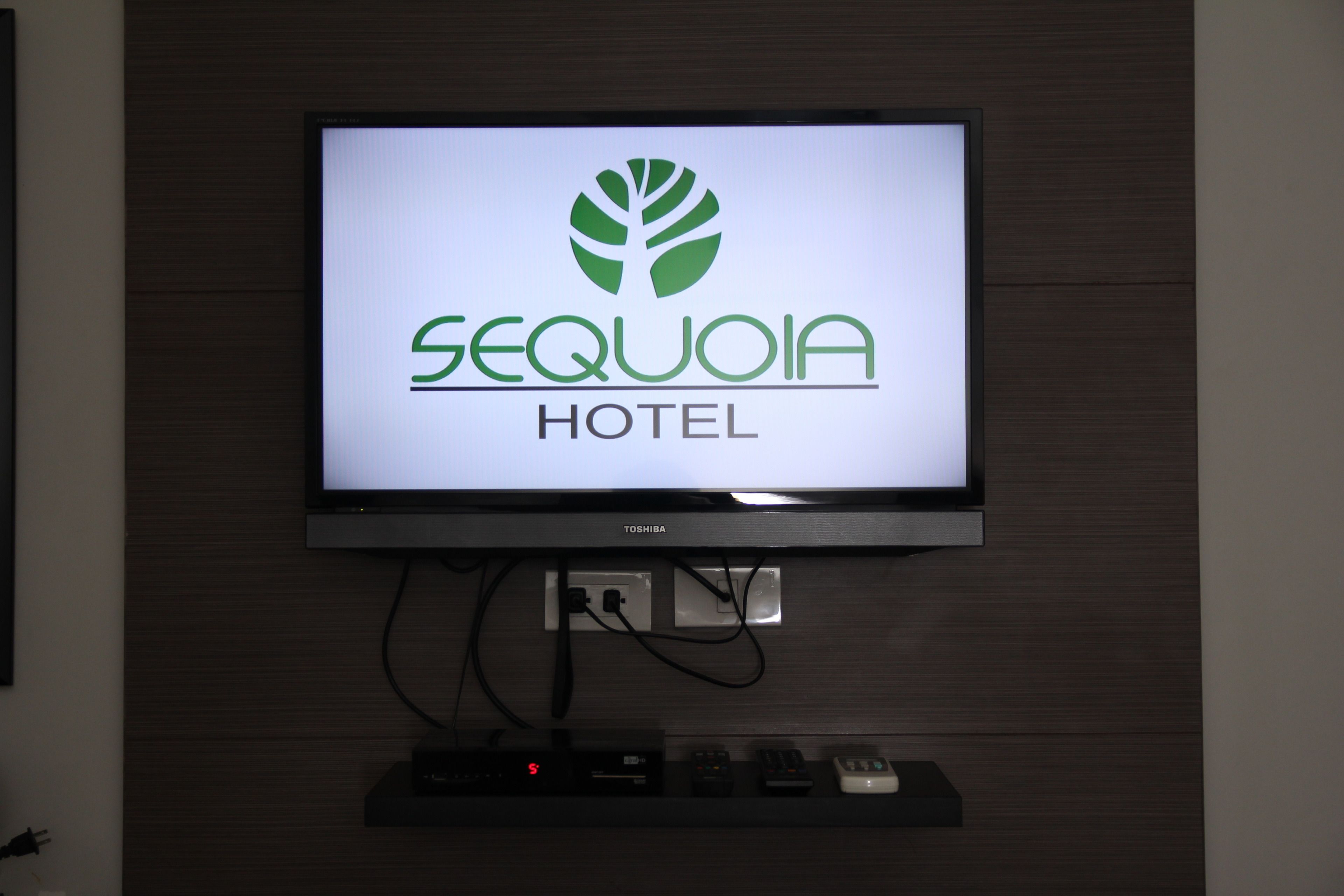 A television screen displaying the Sequoia Hotel logo.