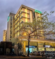A hotel with multiple floors, a visible restaurant named "Style Hub," and a parking area with cars.