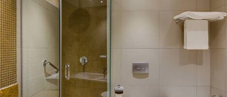 A modern bathroom with a glass-enclosed shower, a white toilet, a bathtub, and a towel rack.