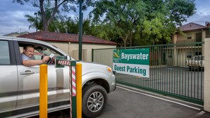 A guest parking area with a sign for Bayswater Hotel. - Quality Hotel Bayswater (Bayswater)