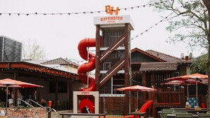 A Bayswater Hotel with outdoor seating, a red slide, and string lights. - Quality Hotel Bayswater (Bayswater)