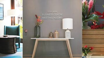 Meetings take place in this well-appointed room with a central table and comfortable seating.