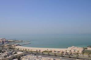 A coastal cityscape with a beach, roads, and buildings. - Residence Inn by Marriott Kuwait City (Kuwait City)