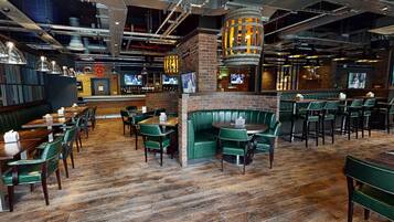 A restaurant with booths, tables, and a bar area.