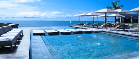 Piscine extérieure, parasols de plage, chaises longues