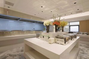 A hotel reception area with a marble floor, a reception desk, and a large window. - Yinguang International Hotel (Taizhou)