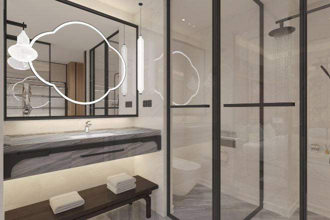Un baño moderno con cabina de ducha de vidrio, lavamanos de mármol y espejo con luz integrada.