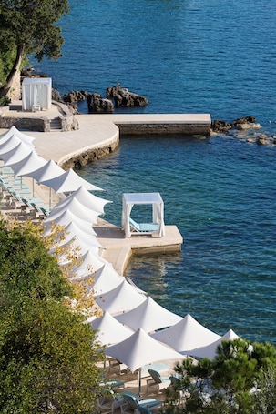 On the beach, sun-loungers, beach umbrellas, beach towels. Amadria Park Hotel Royal