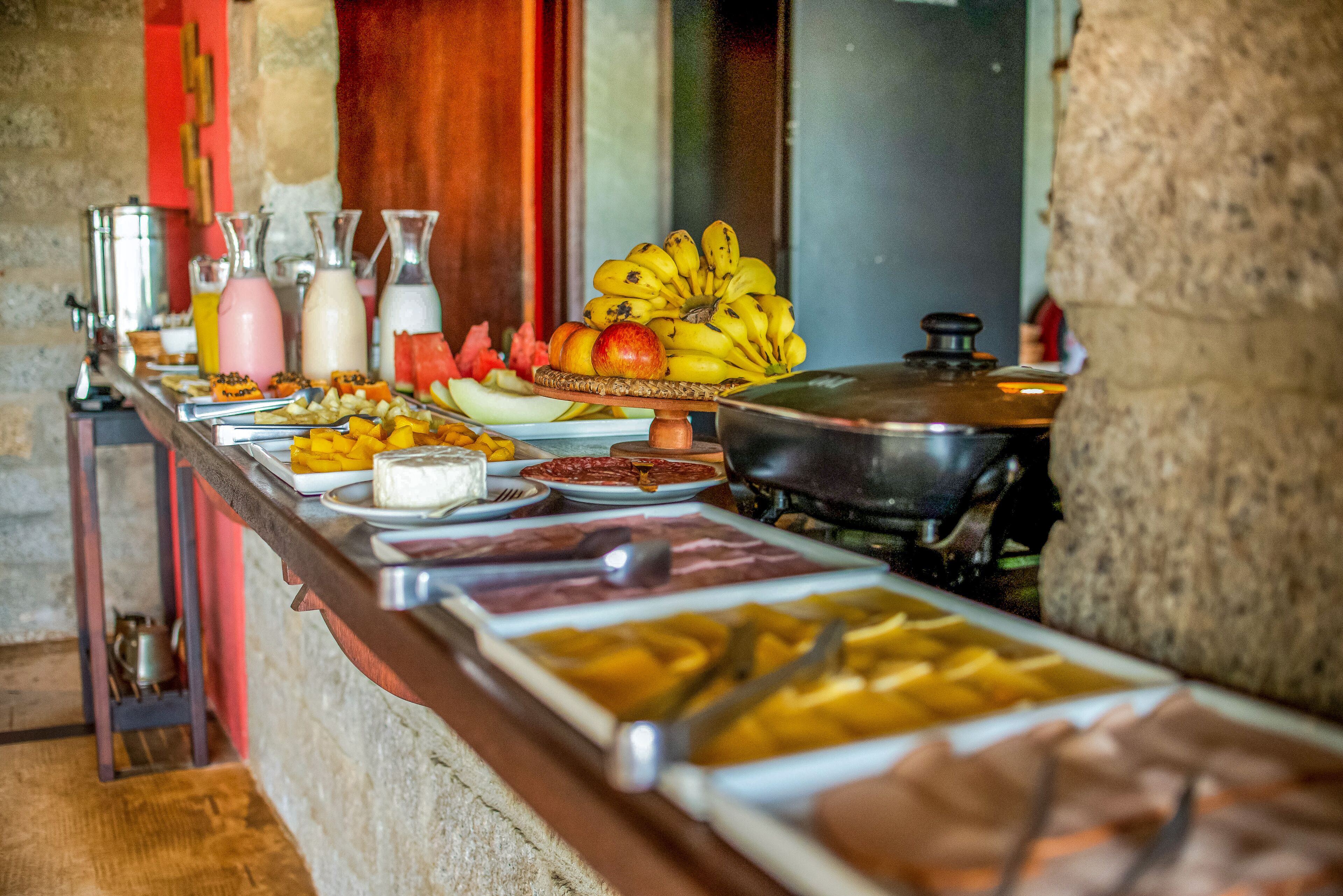 A buffet with various food items and condiments.