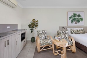 Executive Self Contained Rooms | Living area | 43-inch Smart TV with digital channels, iPod dock - Beachside Boutique Motel Mackay (East Mackay)