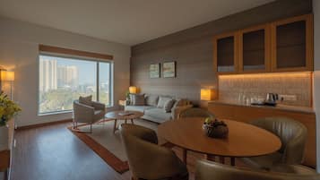 Premier Suite | Living area | 65-inch LED TV with satellite channels, TV