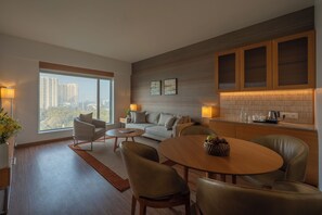 Premier Suite | Living area | 65-inch LED TV with satellite channels, TV