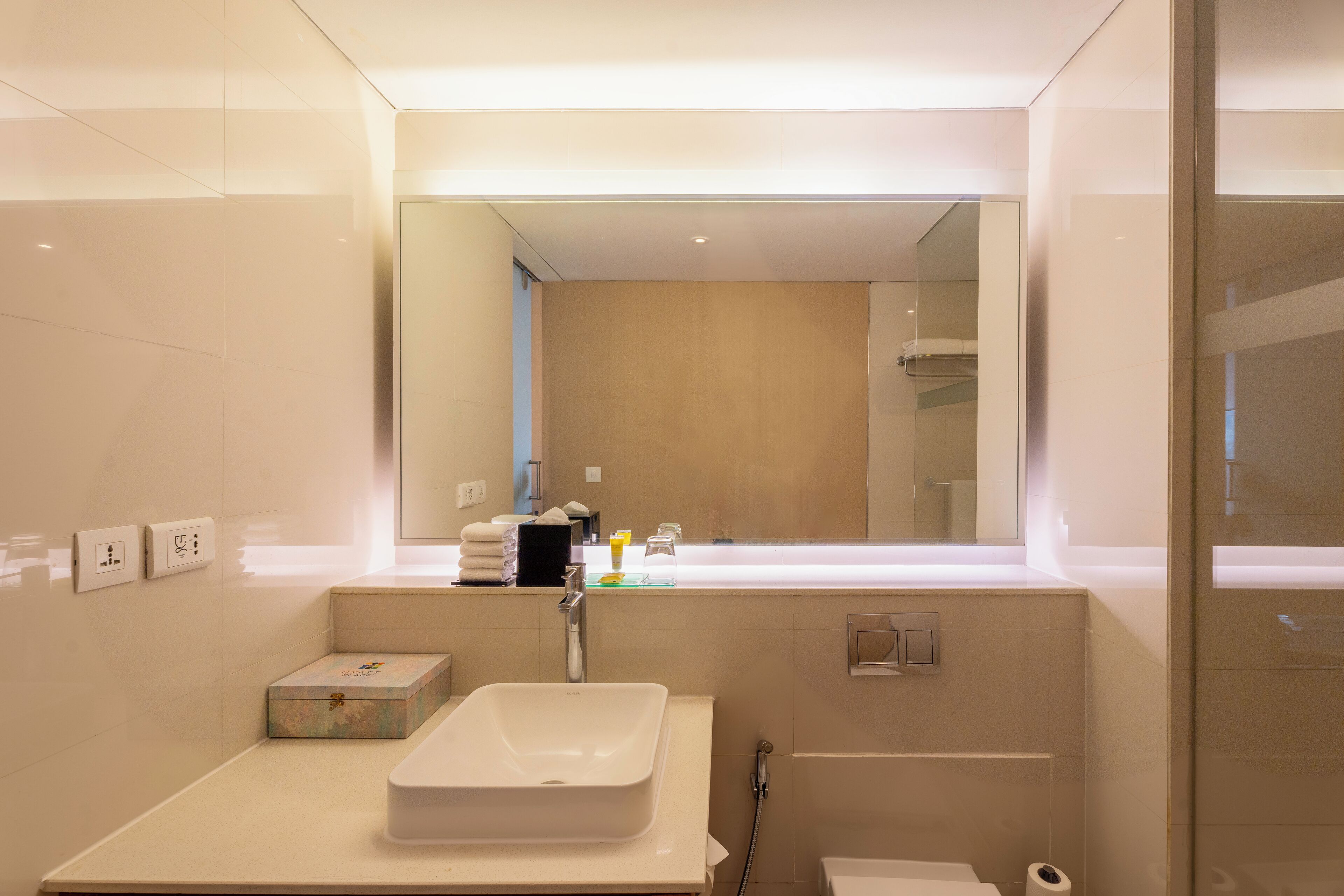 designer toiletries, hair dryer, slippers, towels