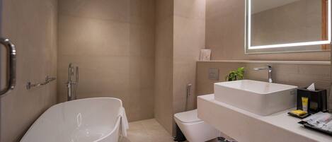 A modern bathroom with a freestanding bathtub, a shower, and a vanity with a mirror.