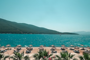 On the beach, sun loungers, beach umbrellas, beach bar