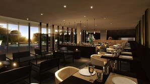 A modern restaurant with a pool view, long dining tables, and a bar area. - Fiesta Residences Boutique Hotel and Serviced Apartments (Accra)