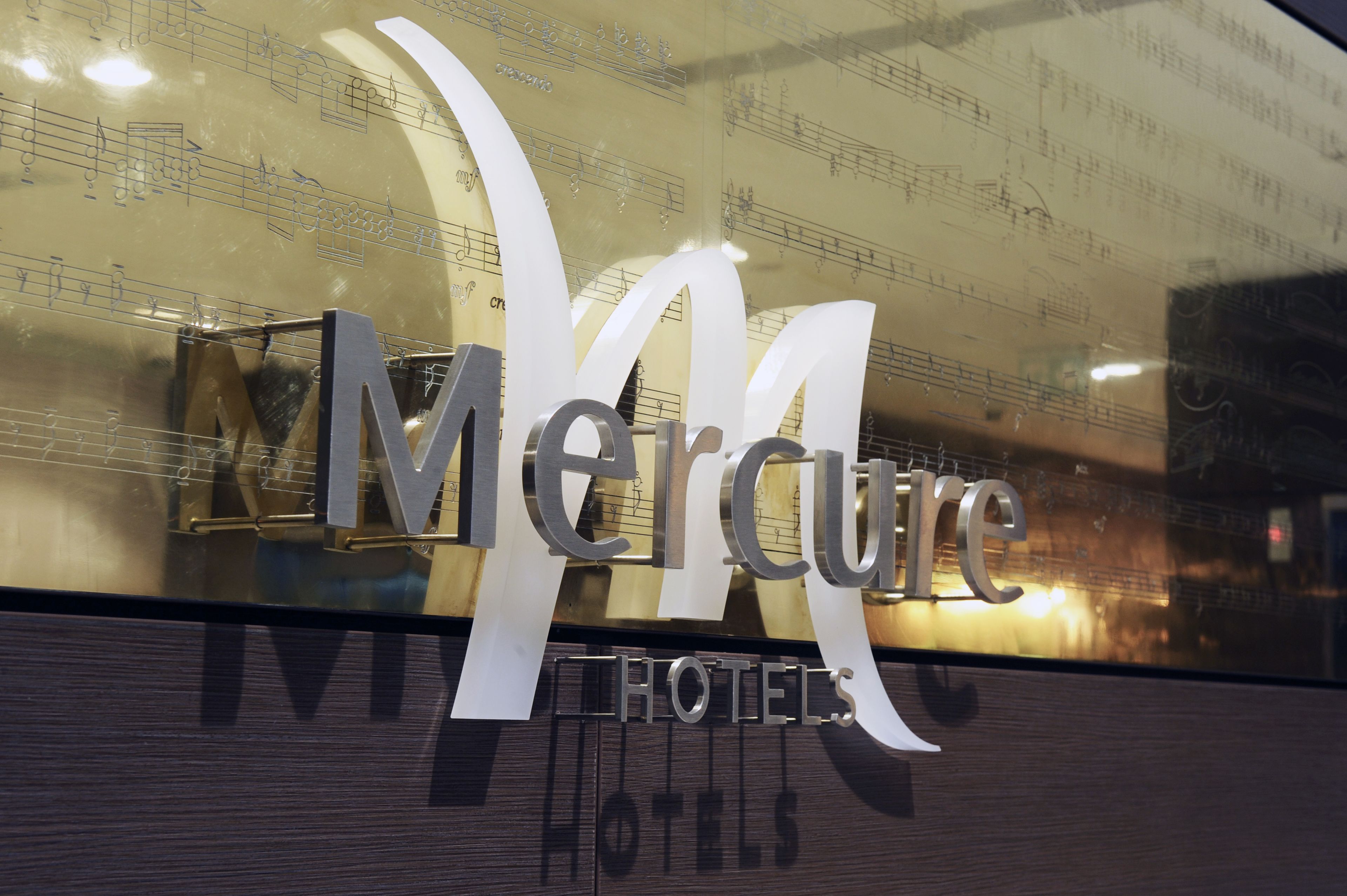 A hotel sign with the name "Mercure Hotels" and a large 'M' logo.