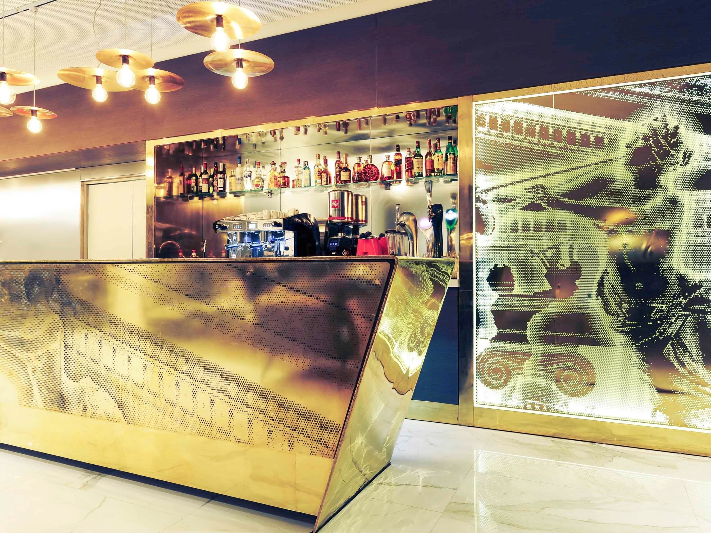 A modern bar area with a polished counter and a digital display.
