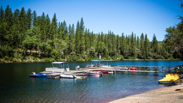 A lake with docked boats and a pier. - Lake of the Springs RV Resort (Oregon House)
