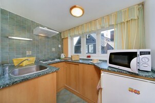 Apartamento família, 2 quartos | Cozinha americana privada | Geladeira, chaleira elétrica