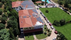 A hotel with a rooftop solar panel array, a swimming pool, and a beach view. - Maranton Beach Hotel (Thasos)