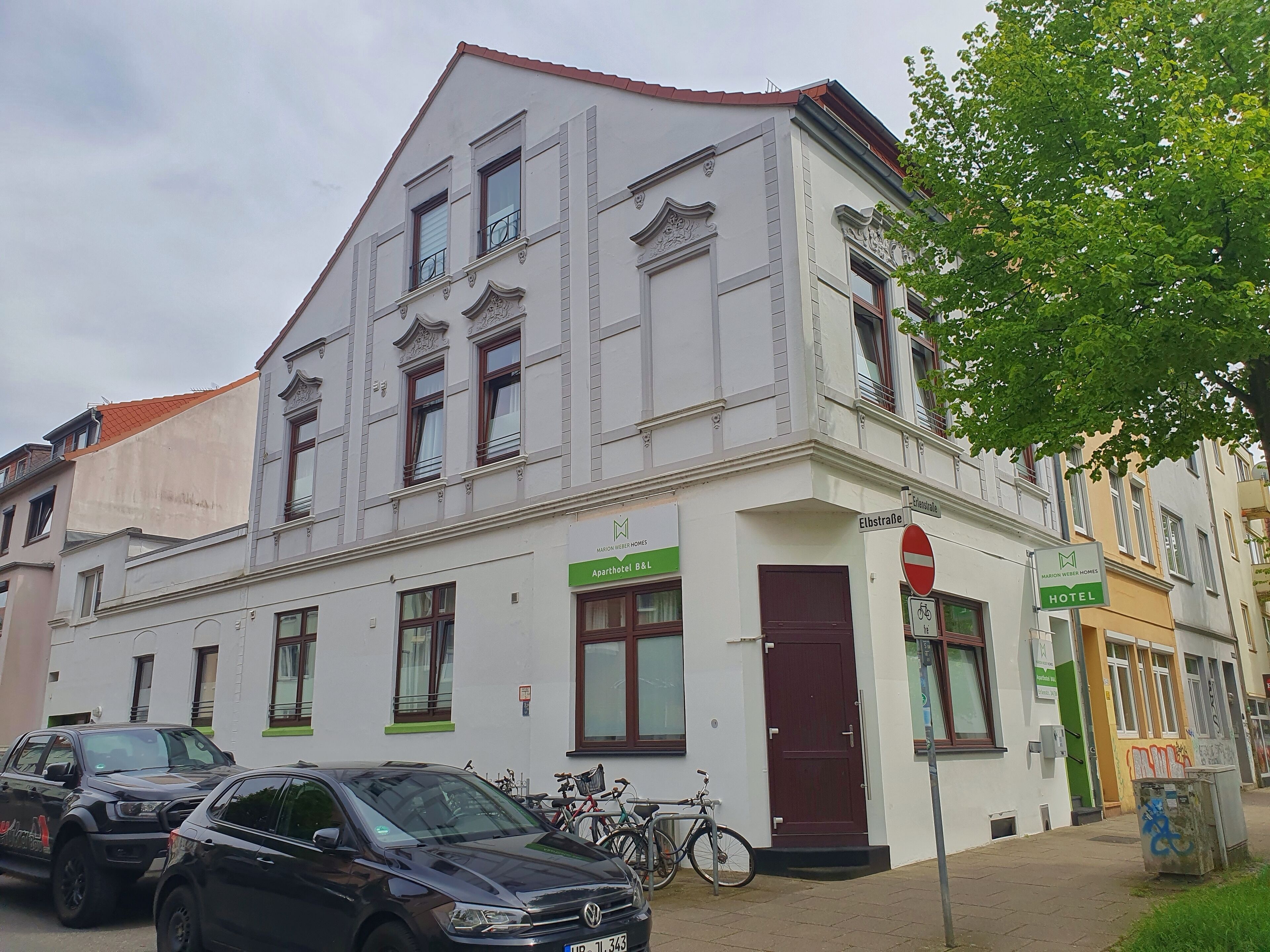 A two-story building with a sign indicating it is a hotel.