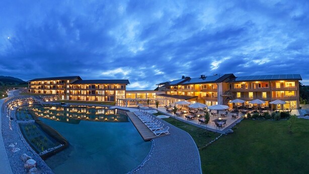 A hotel with multiple buildings, a swimming pool, and outdoor seating areas. - Hotel Nesselwanger Hof (Nesselwang)