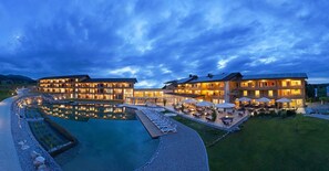 A hotel with multiple buildings, a swimming pool, and outdoor seating areas. - Hotel Nesselwanger Hof (Nesselwang)
