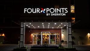 A hotel entrance with a sign reading "FOUR POINTS BY SHERATON".