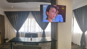 A conference room with a large table, chairs, and a television mounted on the wall. - JB Central Hotel (Johor Bahru)