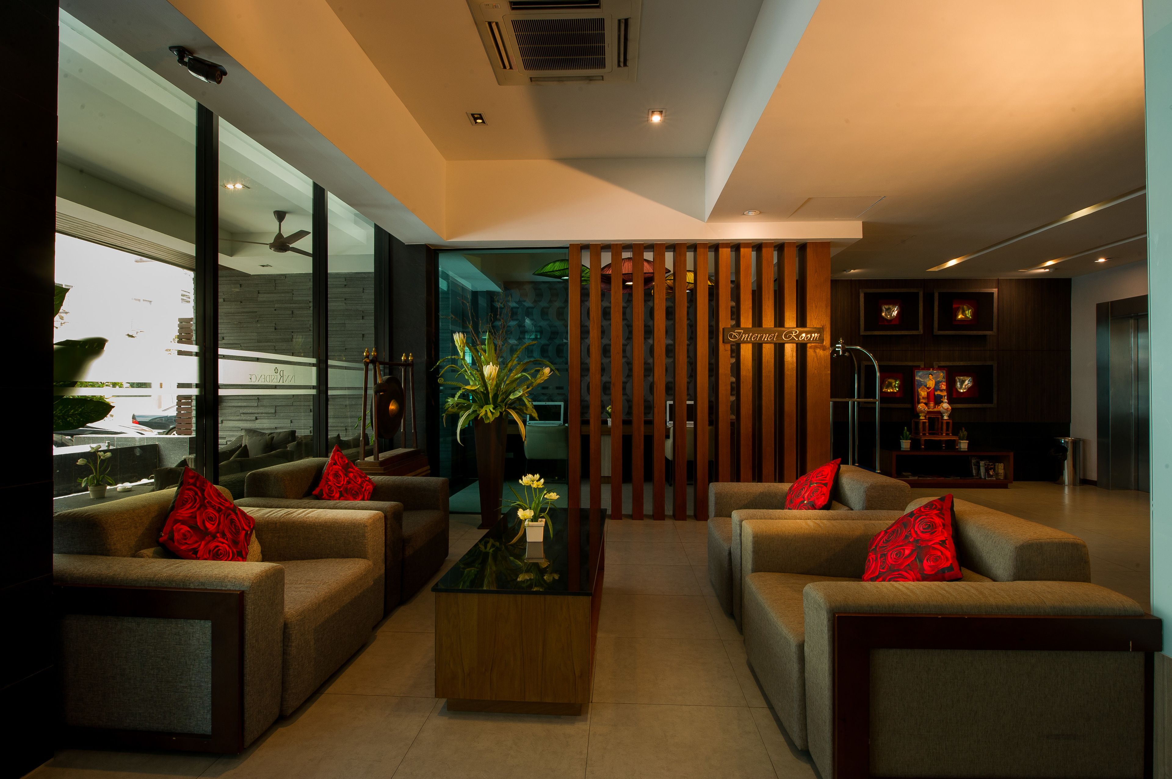 A modern living room with sofas, a coffee table, and a decorative plant.