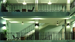 A multi-level interior with balconies, staircases, and hanging lights. - Ruk Cozy Khao Lak (Takua Pa)