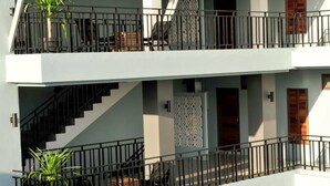 A multi-story building with balconies, staircases, and potted plants. - Ruk Cozy Khao Lak (Takua Pa)