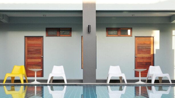 A swimming pool with two doors and two windows on the wall. - Ruk Cozy Khao Lak (Takua Pa)