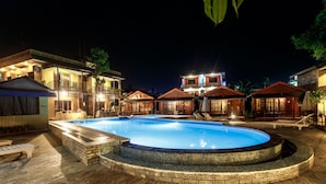 A swimming pool with a tiled edge, surrounded by a brick deck. - The Lakeside Retreat Pokhara by IME Hospitality (Pokhara)