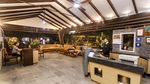 A spacious lobby with a reception desk, seating area, and a ceiling fan. - The Lakeside Retreat Pokhara by IME Hospitality (Pokhara)