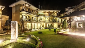 A multi-story hotel with a courtyard, balconies, and a well-maintained garden. - The Lakeside Retreat Pokhara by IME Hospitality (Pokhara)