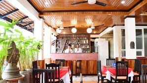 A restaurant with wooden ceiling, tables with red tablecloths, and chairs. - Golden Orchid Angkor (Siem Reap)