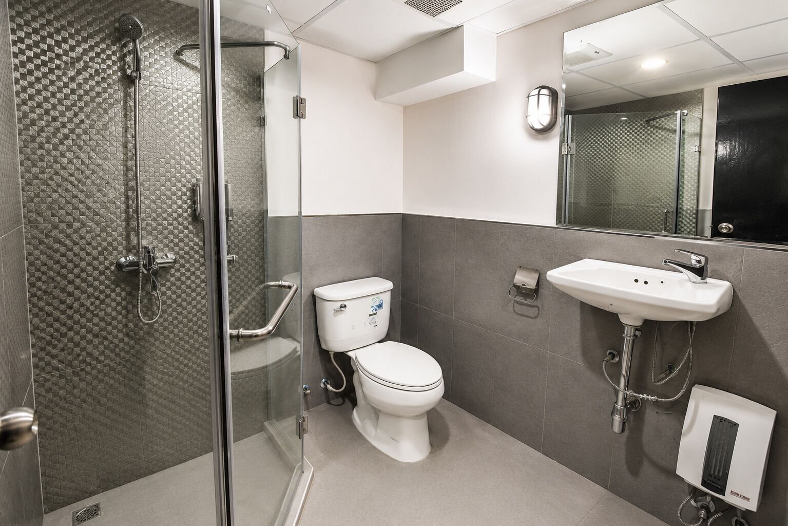 Ein modernes Badezimmer mit einer Duschkabine, einer Toilette und einem Waschbecken.
