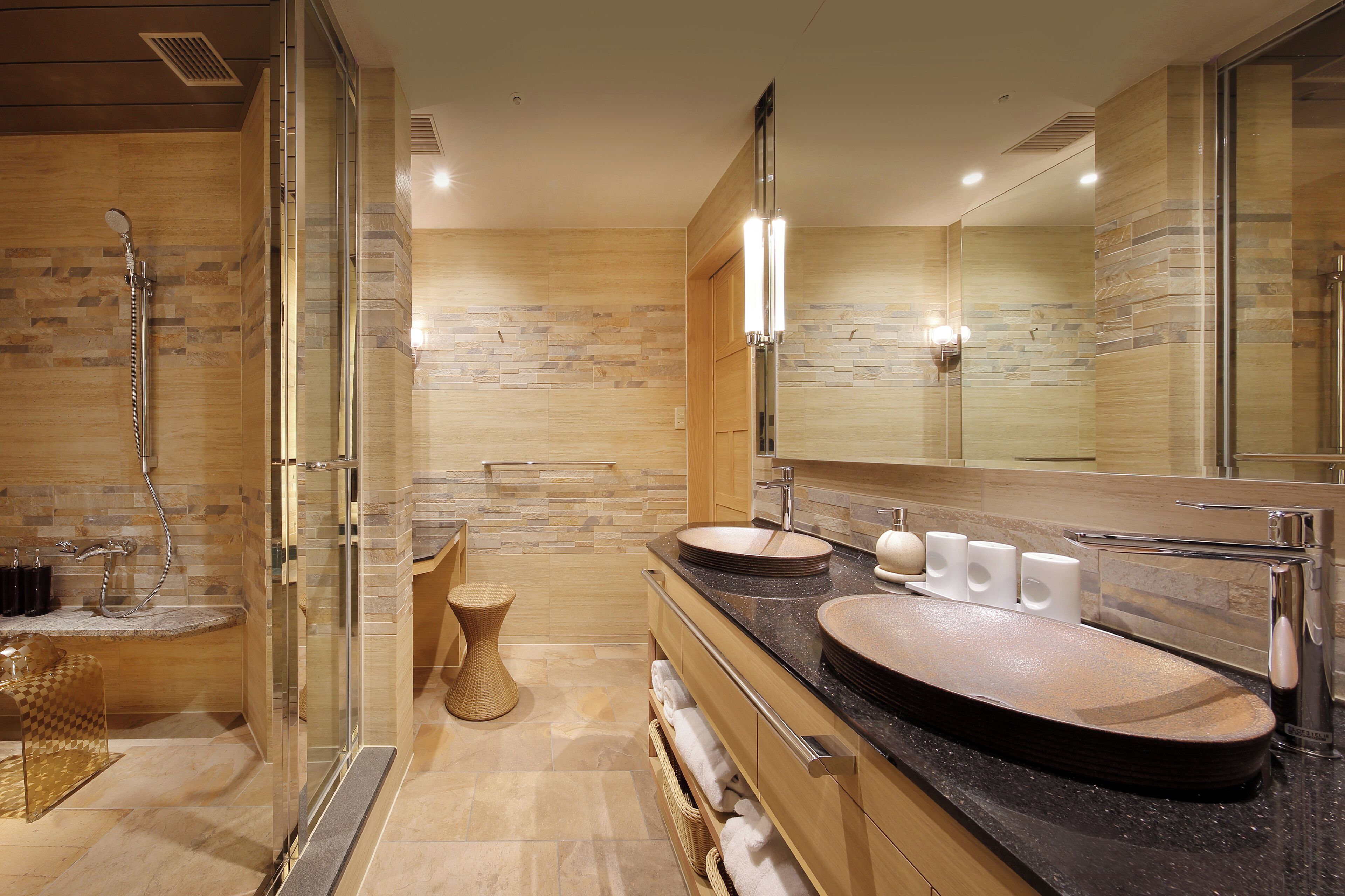 Une salle de bain moderne avec une douche à parois de verre, un meuble-lavabo doté de deux vasques et un grand miroir.