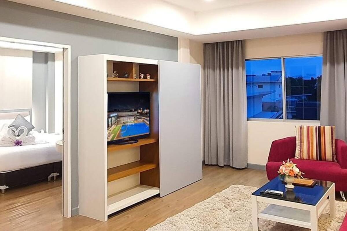 A modern living room with a sofa, a coffee table, and a TV.