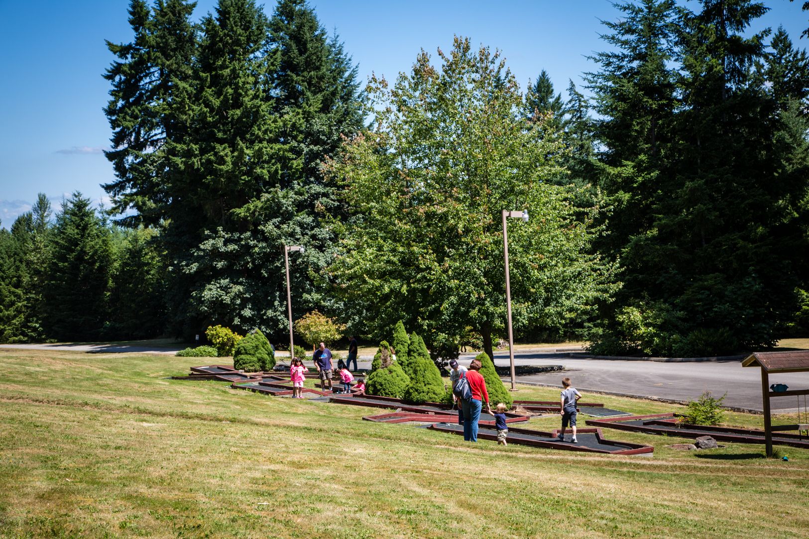 A park with picnic tables and a playground area.