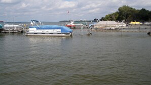 A marina with various boats docked, including a covered boat named 'Whale Rider'. - Lakeland RV Campground (Milton)