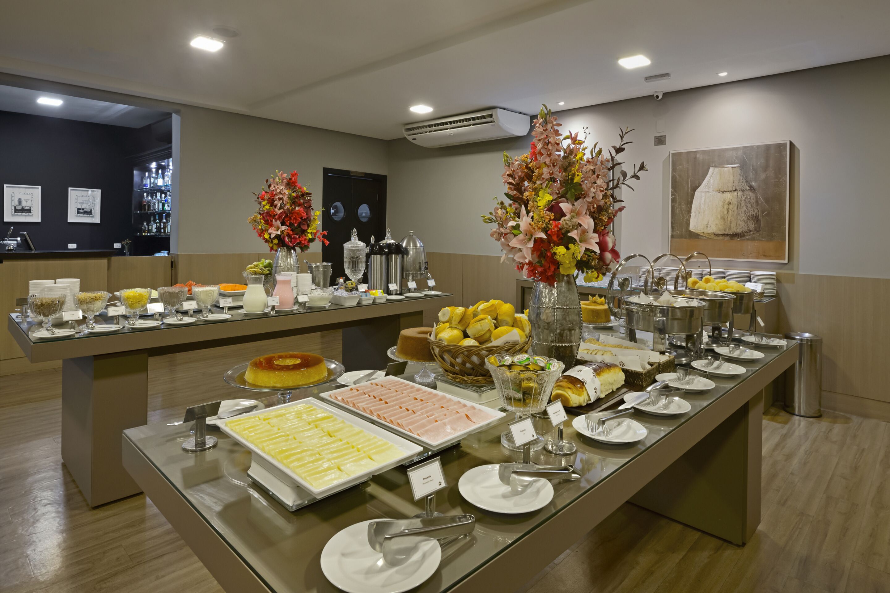 Una mesa de buffet con diversos alimentos y un jarrón decorativo.