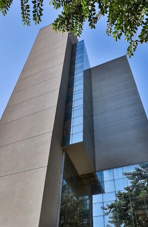 A modern building with a prominent glass facade and a geometric design. - San Diego Express Barro Preto (Belo Horizonte)