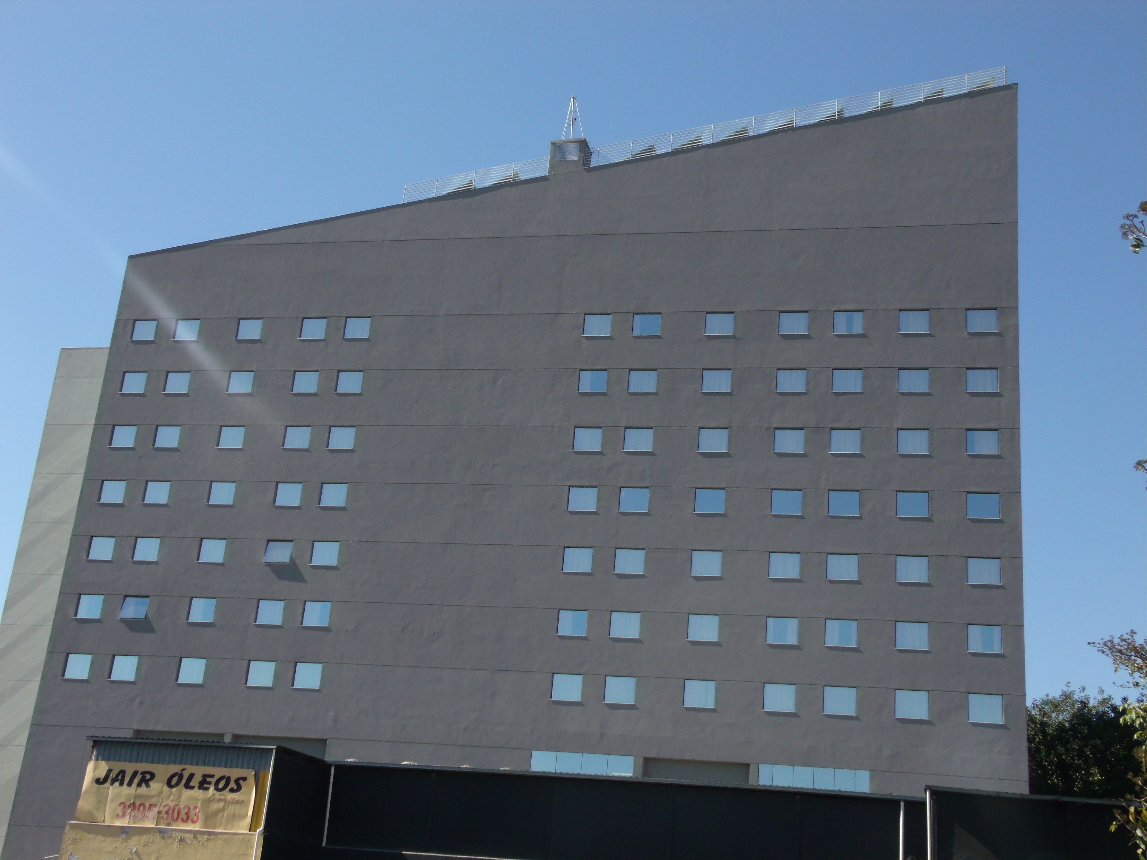 A modern building with a flat roof and numerous windows.